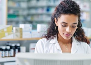 women pharmacist looking at computer screen