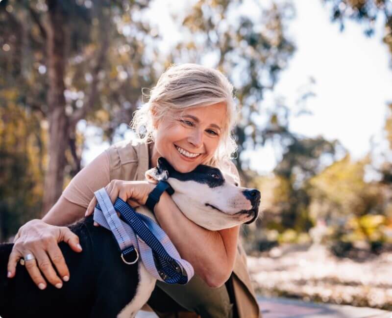 happy woman hugging her dog