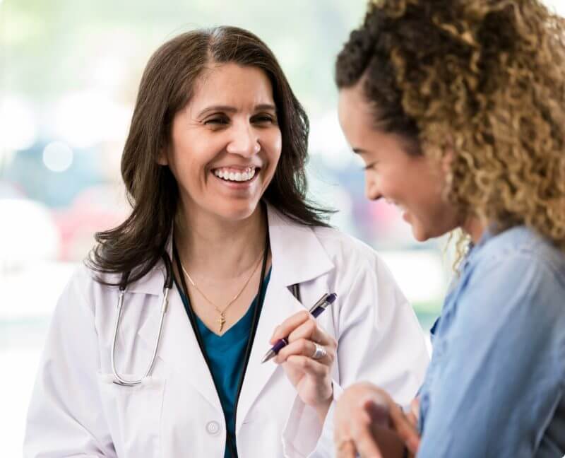 smiling doctor talking to patient